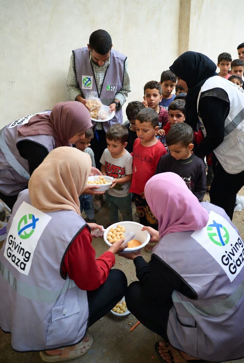 Giving for Gaza volunteers handing support to families