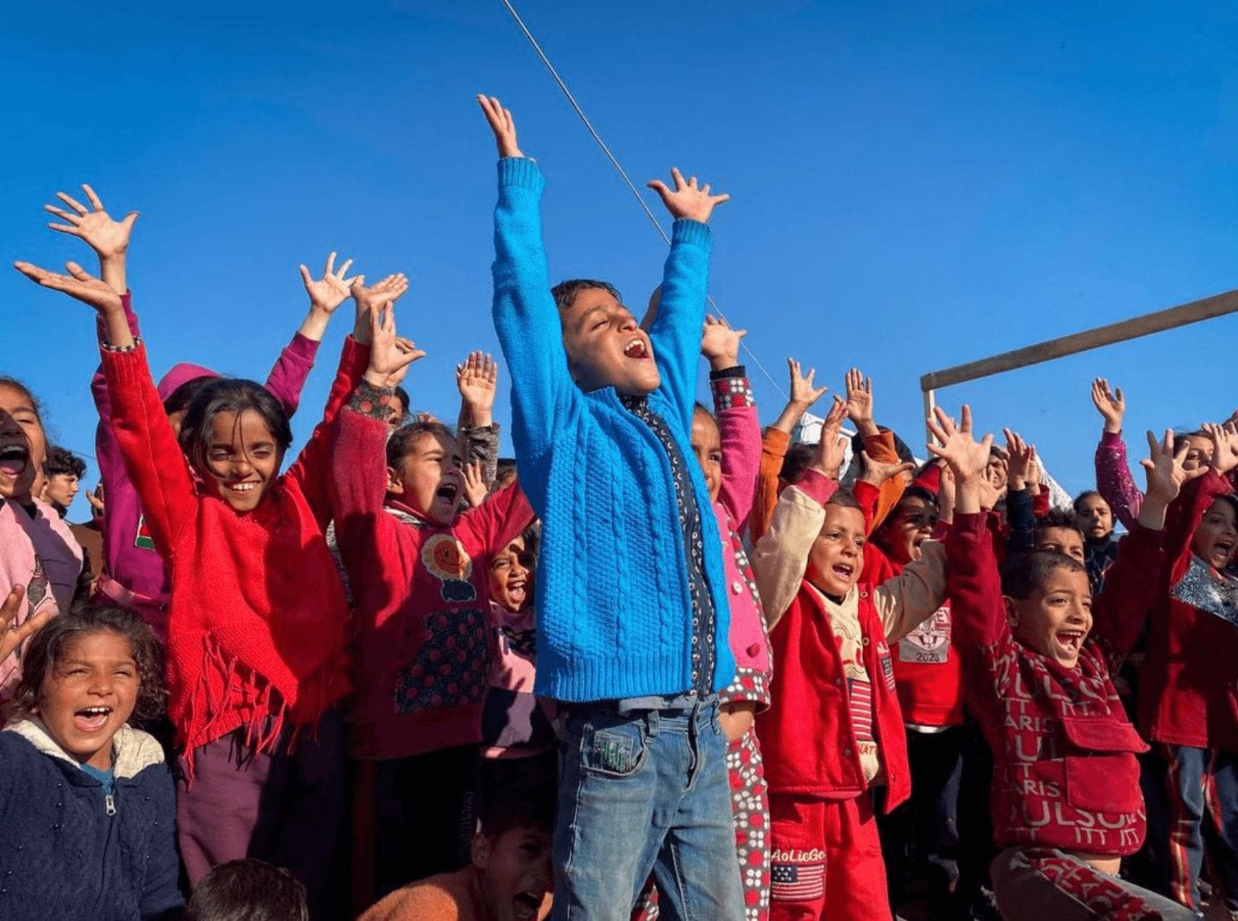 Kids laughing with community volunteers during a performance